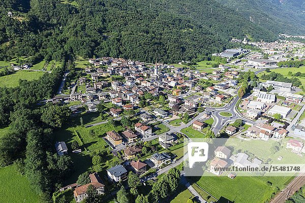 Hang gliding over the village of Rogolo lower Valtellina Sondrio province Lombardy Italy.
