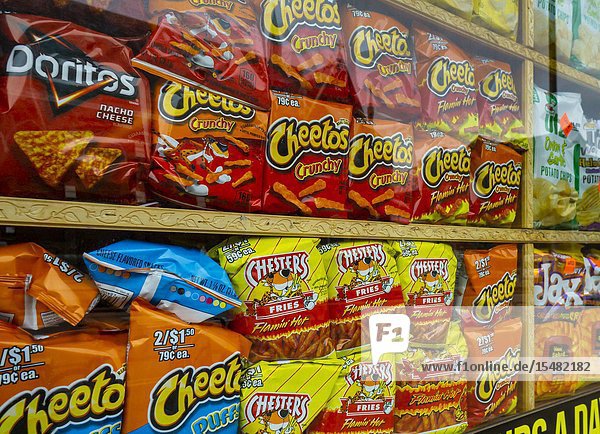 A window display of tasty Frito-Lay brand Cheetos chips with other snacks in New York on Sunday April 28 2019. Frito-Lay is a brand of Pepsico. (© Richard B. Levine).