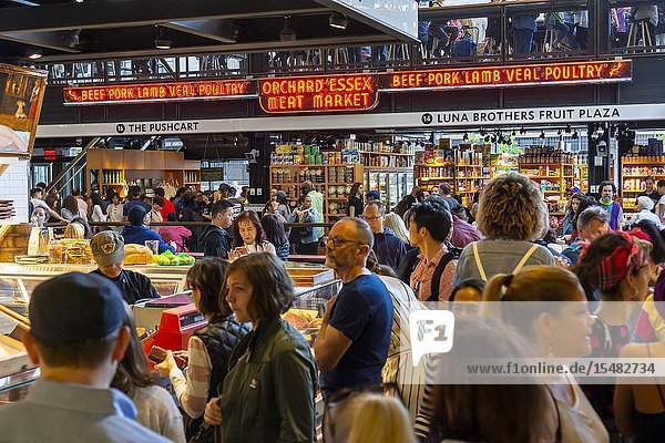 Hundreds of foodies crowd and queue up the newly opened Essex Market in the Lower East Side in New York on its opening weekend Saturday May 18 2019. The new market replaces the older Essex Street Market that dates back to Mayor LaGuardia who created the markets to remove pushcart vendors off the streets. The merchants from the now closed market have moved over and are joined by numerous food hall veterans and newbies. (© Richard B. Levine).