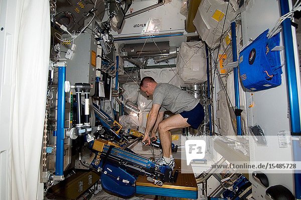 NASA astronaut Kevin Ford  Expedition 34 commander  uses the short bar for the advanced Resistive Exercise Device (aRED) equipment to perform upper body strengthening pull-ups in the Tranquility node of the International Space Station.