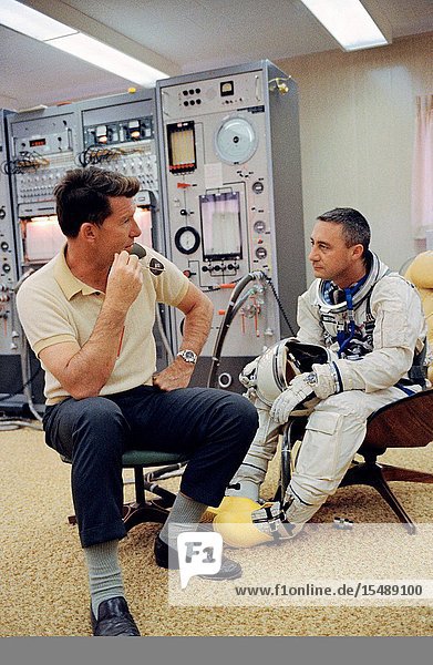 Astronaut Virgil I. Grissom (right) the command pilot of the Gemini-Titan 3 three-orbit mission is shown with astronaut Walter M. Schirra Jr. in the ready room at Pad 16. The GT-3 was launched from Pad 19 the same day. Schirra was the command pilot of the backup crew.