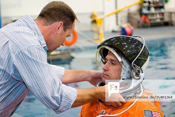 Astronaut William A. Oefelein  STS-116 pilot  gets help with the final touches on his training version of a shuttle launch and entry suit prior to the start of an emergency egress training session in the Neutral Buoyancy Laboratory (NBL) near Johnson Space Center. Suit technician Drew Billingsley assisted Oefelein.