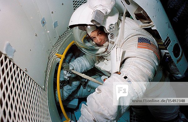 Astronaut Catherine G. Coleman  STS-73 mission specialist  wearing a high-fidelity training version of an Extravehicular Mobility Unit (EMU)  trains for a contingency space walk at the Johnson Space Center's (JSC) Weightless Environment Training Facility (WET-F).
