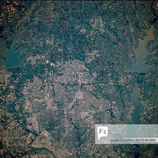 The northern two-thirds of Dallas and such peripheral cities as Richardson Plano Allen and McKinney to the north are featured in this near-vertical photograph of a region experiencing tremendous population growth. Visible are the central business district of downtown Dallas (west of center) the runways of Dallas Love Field (northwest of downtown) and north-south U.S. Highway 75 the Central Expressway. Three large reservoirs and their respective dams are apparent-Garza Little Elm Reservoir northwest of Dallas Lavon Reservoir to the northeast and Lake Ray Hubbard to the east. Visible are White Rock Creek a tributary of the Trinity River meandering southward through central Dallas the street pattern of most of the surrounding cities and cultivated (angular) agricultural fields north of the cities.