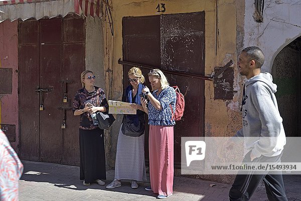 Tourists looking for their way in the Medina of Marrakech Morocco North West Africa.