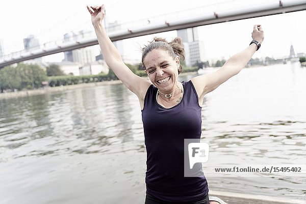 Mid adult woman training at riverside Main in Frankfurt Germany.