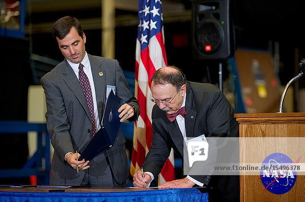 Texas AM University President Dr. R. Bowen Loftin (right) and Paul Hill director of mission operations sign the Space Act Agreement between NASA's Johnson Space Center and Texas AM University on Dec. 19 2011 to begin the move of the primary space shuttle launch and landing trainer the Shuttle Motion Simulator to College Station. The NASA-Texas AM partnership will allow the university to house and showcase unique historical space shuttle training artifacts and the space shuttle training technology it represents will be preserved and used to inspire future engineers. The SMS provided a full-motion simulation of shuttle launches and landings for every crew that flew on the shuttle. It began operations at JSC in 1977 and was used in training for all 135 space shuttle missions.