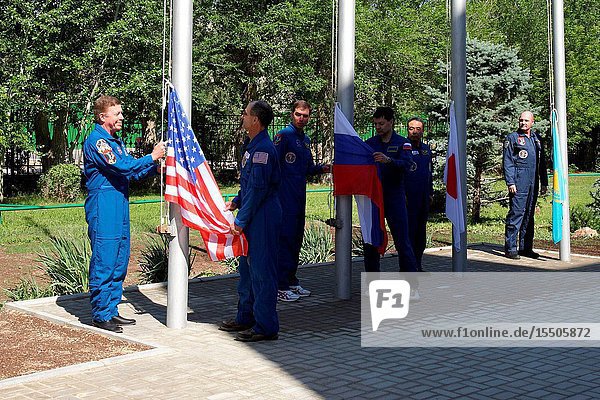 At the Cosmonaut Hotel crew quarters in Baikonur Kazakhstan the Expedition 28 prime and backup crew members participate in the traditional flag raising ceremony May 27 2011 as part of their preparations leading to launch of NASA astronaut Mike Fossum flight engineer Russian cosmonaut Sergei Volkov Soyuz commander and flight engineer and Japan Aerospace Exploration Agency astronaut Satoshi Furukawa flight engineer on June 8 (Kazakhstan time) on the Soyuz TMA-02M spacecraft to the International Space Station. From left to right are Fossum and his backup NASA's Don Pettit Volkov and his backup Oleg Kononenko and Furukawa and his backup Andre Kuipers of the European Space Agency.Victor Zelentsov