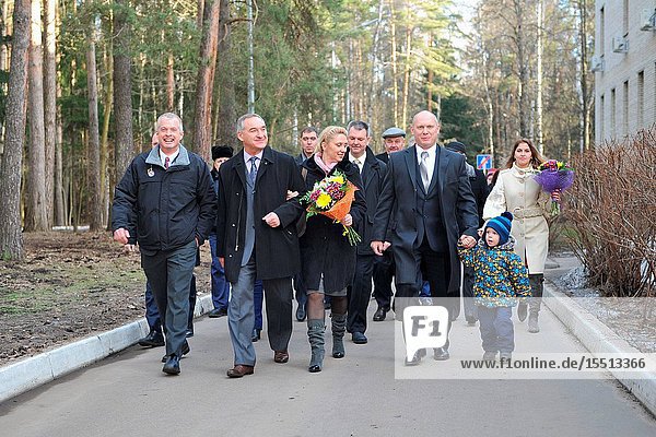 At the Gagarin Cosmonaut Training Center in Star City Russia the Expedition 3940 prime crewmembers and family members walk to a bus March 13 before boarding a plane for the flight to their launch site at the Baikonur Cosmodrome in Kazakhstan. From left to right in the front row are NASA Flight Engineer Steve Swanson Soyuz Commander Alexander Skvortsov of the Russian Federal Space Agency (Roscosmos) his wife and Flight Engineer Oleg Artemyev of Roscosmos and his daughter. Swanson Skvortsov and Artemyev are scheduled to launch to the International Space Station March 26 Kazakh time in the Soyuz TMA-12M spacecraft for a six-month mission.