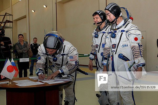 At the Gagarin Cosmonaut Training Center in Star City Russia Expedition 4243 backup crewmember Kjell Lindgren of NASA signs in for the first of two days of qualification exams October 30 as his crewmates Oleg Kononenko of Roscosmos (center) and Kimiya Yui of the Japan Aerospace Exploration Agency look on. They are the backups to the prime crew Terry Virts of NASA Anton Shkaplerov of Roscosmos and Samantha Cristoforetti of the European Space Agency --- who are in the final stages of training for launch November 24 Kazakh time in the Soyuz TMA-15M spacecraft to begin a five and a half month mission on the International Space Station.