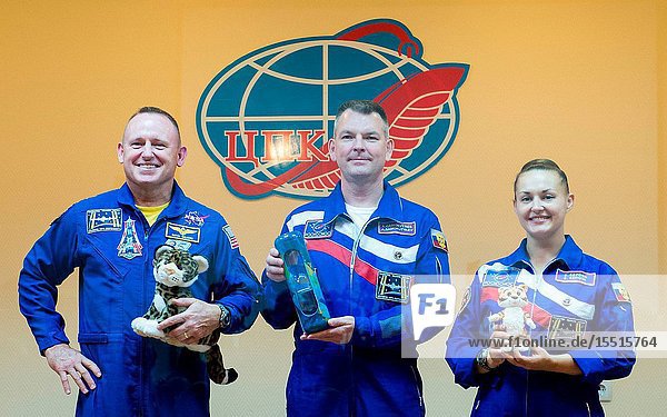 Expedition 41 prime crew members  Flight Engineer Barry Wilmore of NASA  left  Soyuz Commander Alexander Samokutyaev of the Russian Federal Space Agency (Roscosmos)  center  and Flight Engineer Elena Serova of Roscosmos pose for a photo with items they will take with them to the International Space Station at the conclusion of the press conference held at the Cosmonaut Hotel in Baikonur  Kazakhstan on Sept. 24  2014. The mission is set to launch Sept. 26  Kazakh time  from the Baikonur Cosmodrome.Aubrey Gemignani