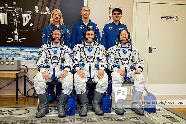 In the Integration Facility at the Baikonur Cosmodrome in Kazakhstan the Expedition 46-47 prime and backup crewmembers pose for pictures Dec. 1 during a fit check dress rehearsal. In the front row are prime crewmembers Tim Peake of the European Space Agency (left) Yuri Malenchenko of the Russian Federal Space Agency (Roscosmos center) and Tim Kopra of NASA (right). In the back row from left to right are backup crewmembers Kate Rubins of NASA (left) Anatoly Ivanishin of Roscosmos and Takuya Onishi of the Japan Aerospace Exploration Agency (JAXA). Kopra Peake and Malenchenko will launch Dec. 15 from Baikonur in the Soyuz TMA-19M spacecraft for a six-month mission on the International Space Station. NASAVictor Zelentsov