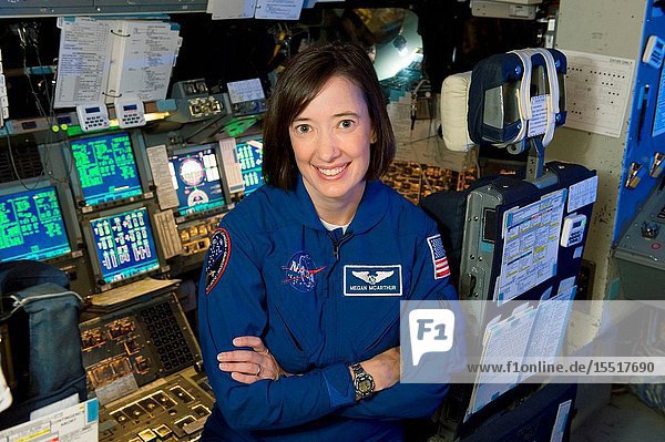 Portrait of Astronaut Megan McArthur (in blue flight suit) taken in Bldg. 5 Motion Based Simulator.