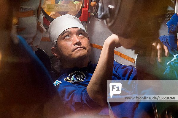 In the Integration Facility at the Baikonur Cosmodrome in Kazakhstan Expedition 48-49 crewmember Takuya Onishi of the Japan Aerospace Exploration Agency conducts a fit check familiarization aboard the Soyuz MS-01 spacecraft June 25 as part of the preparations for launch with Anatoly Ivanishin of Roscosmos and Kate Rubins of NASA on July 7 Baikonur time for a planned four-month mission on the International Space Station..GCTCAndrei Shelepin.