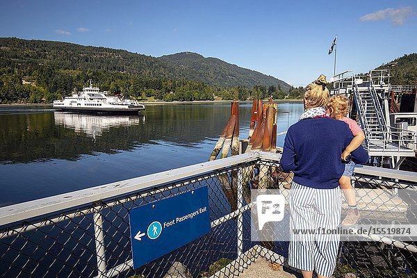 Women and child watching BC Ferries Skeena Queen arriving at Fulford Harbour - Salt Spring Island British Columbia Canada.