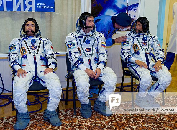 Expedition 32 JAXA Flight Engineer Akihiko Hoshide left Soyuz Commander Yuri Malenchenko and NASA Flight Engineer Sunita Williams wait after having their Sokol suits pressure checked in preparation for their launch onboard the Soyuz TMA-05M on Sunday July 15 2012 at the Baikonur Cosmodrome in Kazakhstan. The launch of the Soyuz spacecraft with Hoshide Malenchenko and Williams is scheduled for the morning of Sunday July 15 local time. Photo Credit: (NASAGCTCIrina Peshkova)