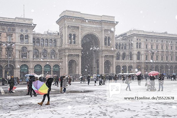 The gallery of Vittorio Emanuele II and Piazza Duomo in winter during snowfall Milan Lombardy Italy Europe.