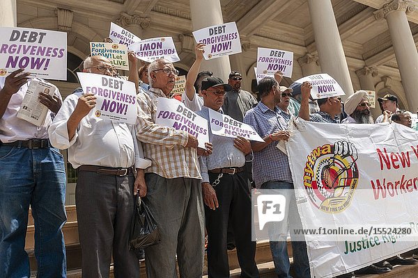 New York taxi drivers and their supporters rally on the steps of NY City Hall in Thursday July 11 2019 for a news conference calling for debt forgiveness for their medallion loans. Medallion brokers allegedly took advantage of drivers who bought medallions at artificially inflated prices and ended up burdened with debt. A number of drivers have filed for bankruptcy or are considering it and there have been a few suicides amongst stressed drivers. (© Richard B. Levine).