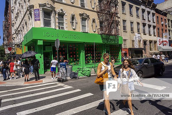 Appealing to millennials a Louis Vuitton pop-up attracts crowds willing to wait on line to enter in the heart of New York's hip Lower East Side neighborhood seen on Saturday July 13 2019. The space is covered both inside and out in a color normally reserved for television green screens and highlights selections from their artistic director Virgil Abloh's new collection. (© Richard B. Levine).