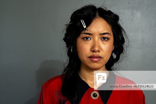 Tilburg Netherlands. Studio portrait of a beautiful Korean female student looking angry.