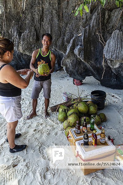 A Local Man Selling Cold Drinks and Buko Juice At Entalula Beach El Nido Palawan The Philippines.