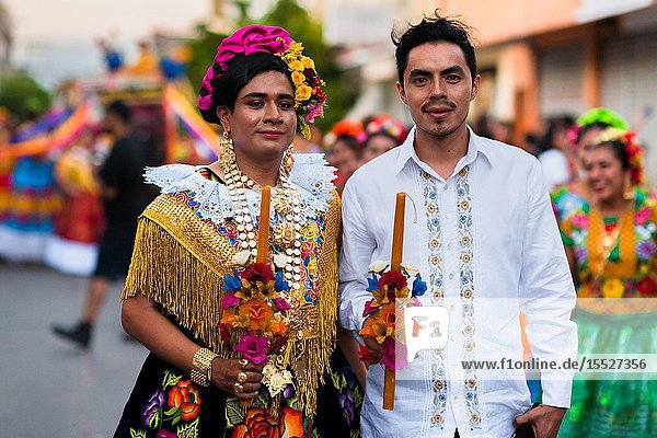 A Mexican â. œmuxeâ.(typically a homosexual man wearing female clothes) posing with her boyfriend takes part in the traditional procession during the Vela de las Intrépidas festival in Juchitán de Zaragoza Oaxaca Mexico 17 November 2018. In the Istmo de Tehuantepec region of southern Mexico the Zapotec indigenous society traditionally divides people into three genders: male female and muxes. The â. œthird genderâ.(muxes) generally represents those who identify as a different gender than assigned at birth. Muxes are shown respect they contribute to society as artists merchants or they stay at the parentsâ.home doing womenâ.s work. Although the three gender system originates in pre-Hispanic indigenous culture the phenomenon of muxes dressing publicly as women started in the 1950s and has been gaining popularity until today.