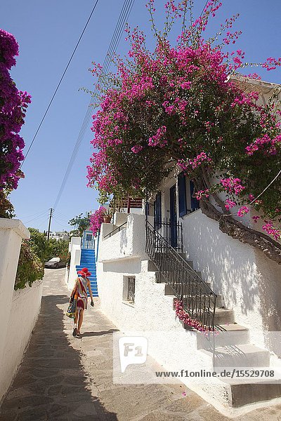 Woman in front of a traditional whitewashed house at the village of Lefkes Paros Cyclades Islands Greek Islands Greece Europe