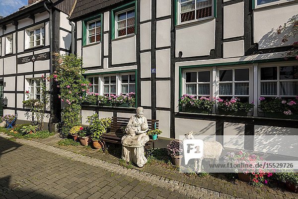 Herten Westerholt Germany North Rhine-Westphalia NRW Westphalia Ruhr area D-Herten D-Herten-Westerholt Old Village Westerholt Alte Freiheit Westerholt half-timbered houses at the Brandstrasse flowers figures sculptures mother and child goat