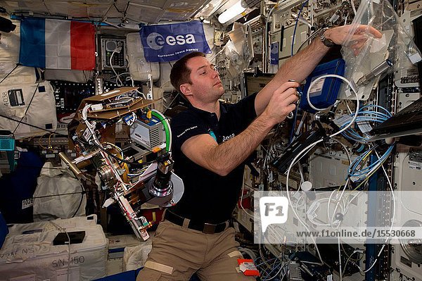 Astronaut Thomas Pesquet of the European Space Agency (ESA) is at work inside the Columbus laboratory module developed by ESA.