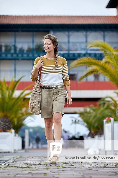 Woman walking near the harbour Sokoburu Hendaye Aquitaine Basque Country France