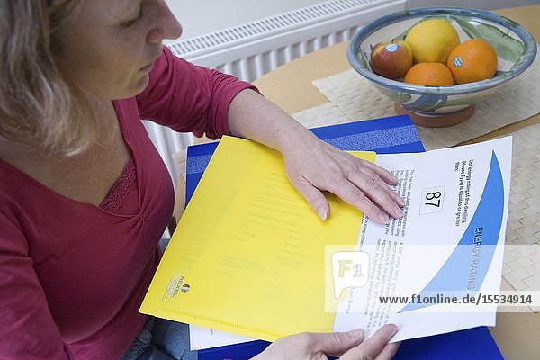 Woman looking at her houses energy rating certificate