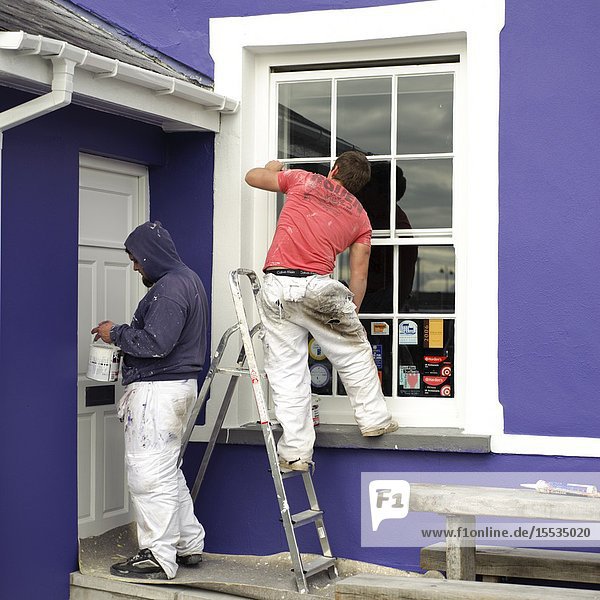 Decorators painting house exterior