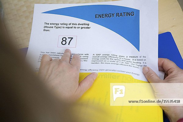 Woman looking at her houses energy rating certificate