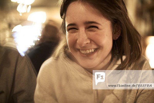 Woman laughing in restaurant