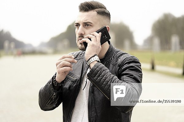 Man talking on cell phone. Munich Germany