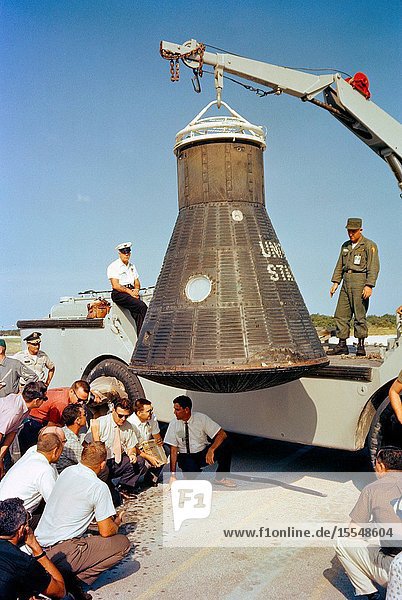 Department of Defense (DOD) recovery personnel and spacecraft technicians from NASA and McDonnell Aircraft Corp. inspect astronaut John Glenn's Mercury spacecraft Friendship 7 following its return to Cape Canaveral after recovery in the Atlantic Ocean.