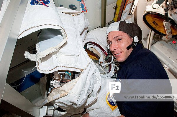 NASA astronaut Michael Hopkins Expedition 38 flight engineer participates in Extravehicular Mobility Unit (EMU) spacesuit tests and repairs in the Quest airlock of the International Space Station.