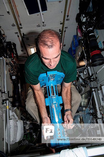 NASA astronaut Rick Mastracchio Expedition 38 flight engineer uses a body mass measurement device (BMMD) in the Zvezda Service Module of the International Space Station.