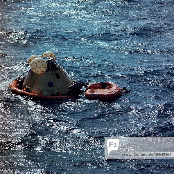 A team of U.S. Navy swimmers assists with the recovery of the Skylab 3 Command Module following its splashdown in the Pacific Ocean about 230 miles southwest of San Diego California. The swimmers had just attached a flotation collar to the spacecraft to improve its buoyancy. Aboard the Command Module were astronauts Alan L. Bean Owen K. Garriott and Jack R. Lousma who had just completed a successful 59-day visit to the Skylab space station in Earth orbit. Minutes later the Command Module with the three crewmen still inside was hoisted aboard the prime recovery ship the USS New Orleans.