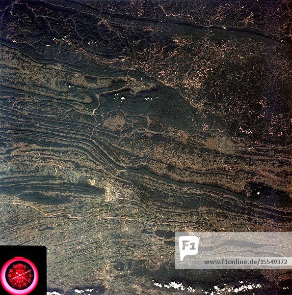 A near vertical view of the Tennessee-Virginia-Kentucky border area is seen in this Skylab 3 Earth Resources Experiments Package S190-B (five-inch Earth terrain camera) photograph taken from the Skylab space station in Earth orbit. The clock is in the most southerly corner of the picture. Interstate 81 under construction extends northeast-southwest across the bottom portion of the photograph. The larger urban area nearest the center of the picture is Kingsport Tennessee. On the southern side of I-80 and east of Kingsport is the city of Bristol Tennessee-Virginia. Johnson City Tennessee is the urban area near the edge of the picture southeast of Kingsport. The Holston River a tributary of the Tennessee River meanders through the Kingsport area. The characteristic ridge and valley features in the Cumberland Plateau of Kentucky Tennessee and Virginia are clearly visible. Forests (dark green) occur on the ridges and clearly outline the folded and faulted rock formations. The valleys (light) were formed in the softer rocks as a result of erosion. Agricultural areas are indicated by the characteristic rectangular patterns. Coal production is an important industry of this area and it is mined by surface open pit operations. The irregular light areas in the Kentucky-Virginia border area are the strip mines which follow the contour of the land. Reclamation of the strip mine areas is aided through accurate knowledge of the mine and drainage systems. Dr. Ronald Brooks of the Wolf Research and Development Corporation can use this photograph in study of strip mine areas in the east central U.S. Federal agencies participating with NASA on the EREP project are the Departments of Agriculture Commerce Interior the Environmental Protection Agency and the Corps of Engineers. All EREP photography is available to the public through the Department of Interior's Earth Resources Observations Systems Data Center Sioux Falls South Dakota 57198.