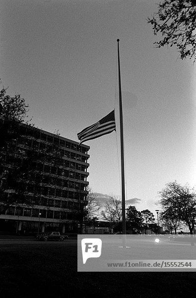 The United States flag  in front of the Johnson Space Center's (JSC) project management building  flies at half-mast in memory of the seven space shuttle Challenger crew members who lost their lives on Jan. 28  1986. Earlier today  memorial services about 100 yards from the flag drew thousands of JSC employees  friends and family of the STS-51L astronauts and payload specialists.