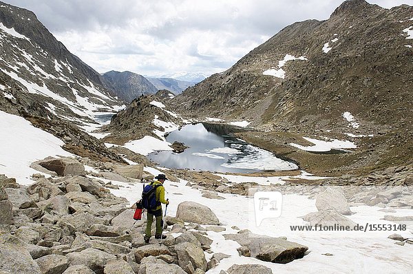 Mountaineer ascending to the peak of Vallibierna Huesca Aragon Spain