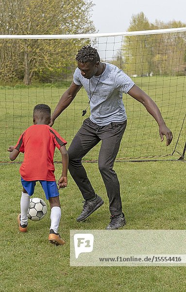 Young soccer player being coached on a football pitch. Hampshire  England UK. April 2019.