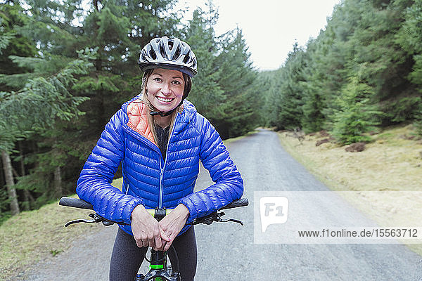 Portrait smiling woman mountain biking