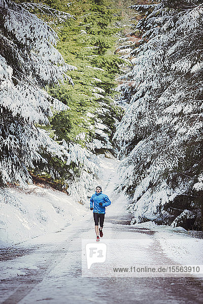 Man jogging in snowy woods