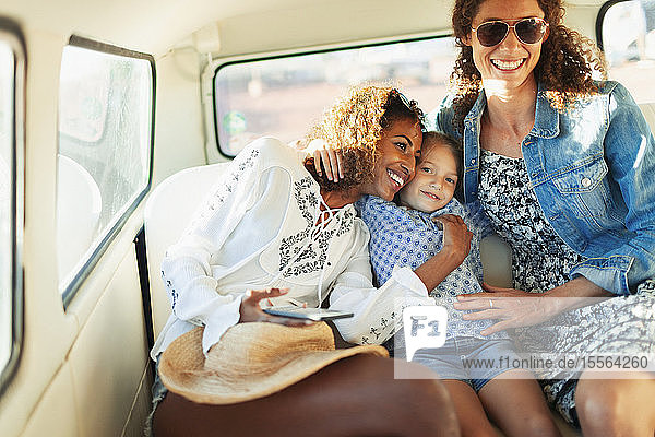 Happy women and girl riding in van