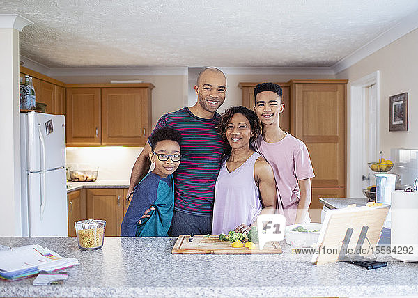 Portrait smiling family cooking in kitchen