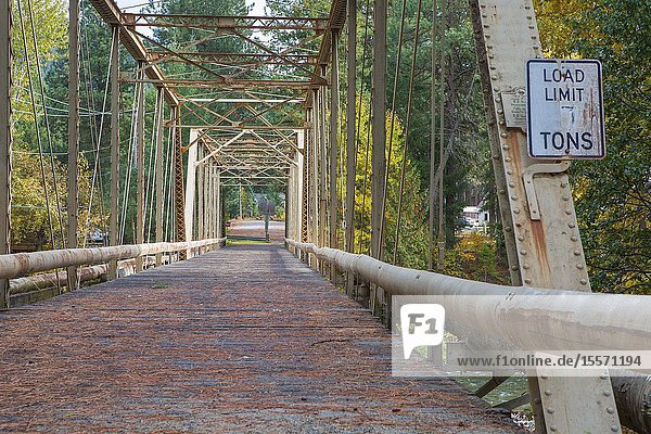 An old steel arch bridge is still used for pedestrians and smaller mechanized machines.