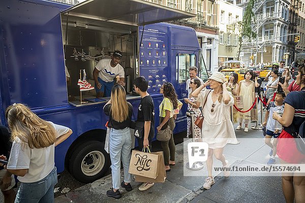 Hordes of ice cream and shoe lovers line up outside the Stuart Weitzman store in Soho in New York on Saturday August 17 2019 for a branding event for Weitzman' s ' Darryl' sneakers. Visitors were teated to Van Leeuwen ice cream from a branded truck with the flavors customized by the colors of Weitzman' s new sneaker line.