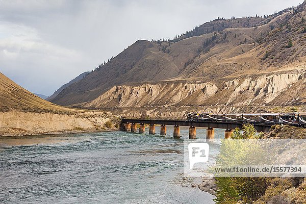 The Rocky Mountaineer tourist train crossing the Thompson River close to Ashford in British Columbia Canada.